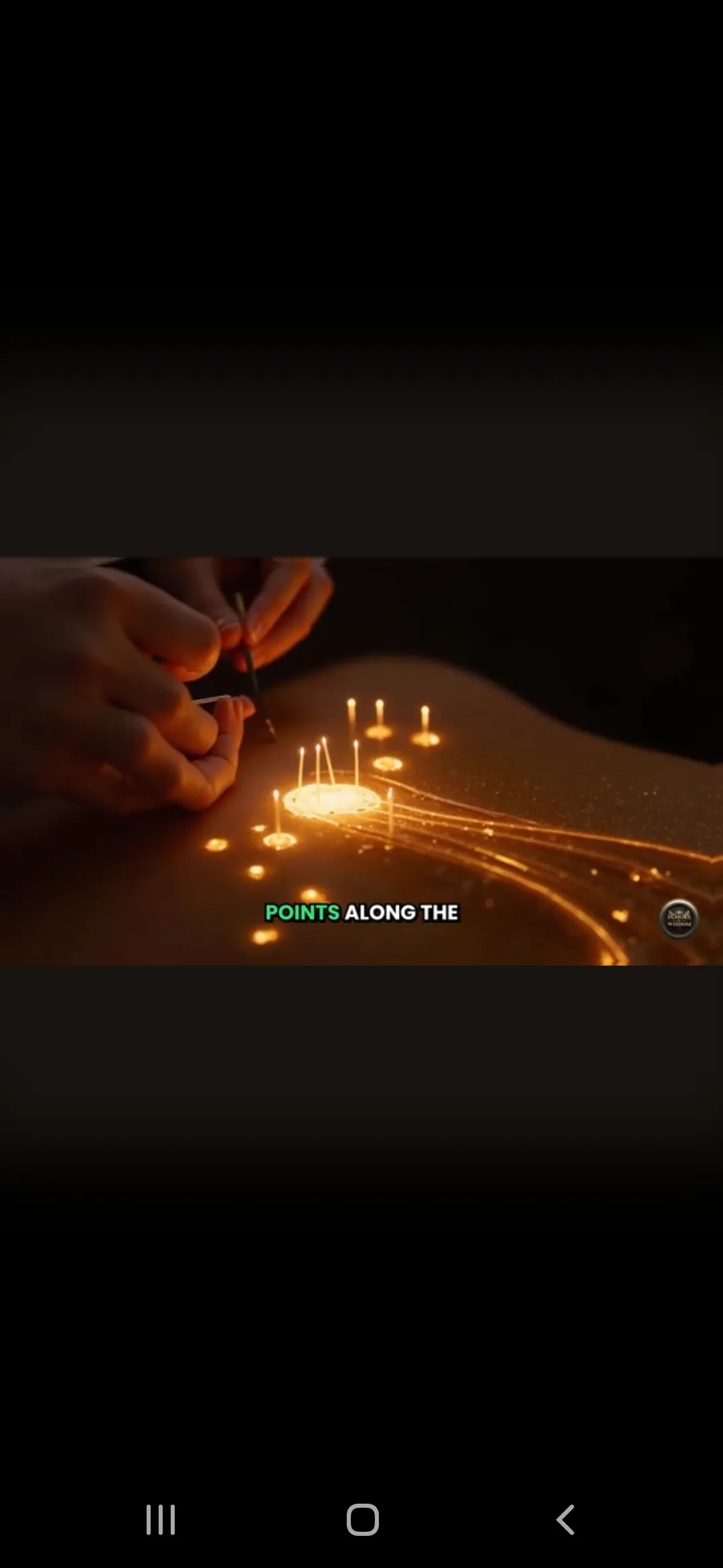 Hands lighting candles on a birthday cake in dim light.